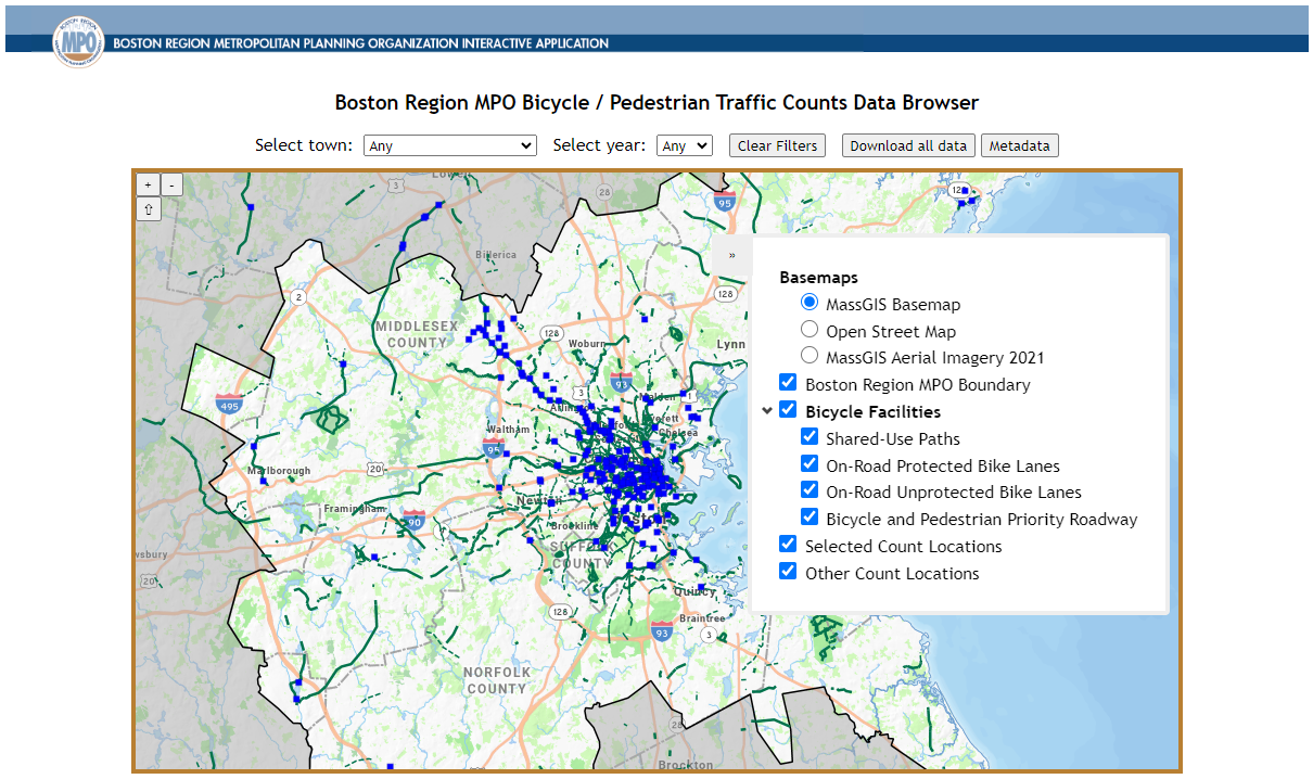 2023 Count Data Application. The screenshot shows what the updated count data application looks like upon opening. The map is zoomed to the Boston MPO region and includes points to indicate where data is available. Above the map are two drop-down menus: “select municipality” and “select year”. To their right are three buttons: “clear filters”, “download all data”, and “metadata”. The right side of the map features a toggleable legend that allows users to select their basemap (either MassGIS basemap, Open Street map, or MassGIS aerial imagery 2021), include or exclude the Boston Region MPO boundary, illustrate the location of different types of bicycle facilities (shared-use paths, on-road protected bike lanes, on-road unprotected bike lanes, and/or bicycle and pedestrian priority roadways), show selected count locations, and decide whether to illustrate the locations of other counts that don’t meet the user’s search criteria.